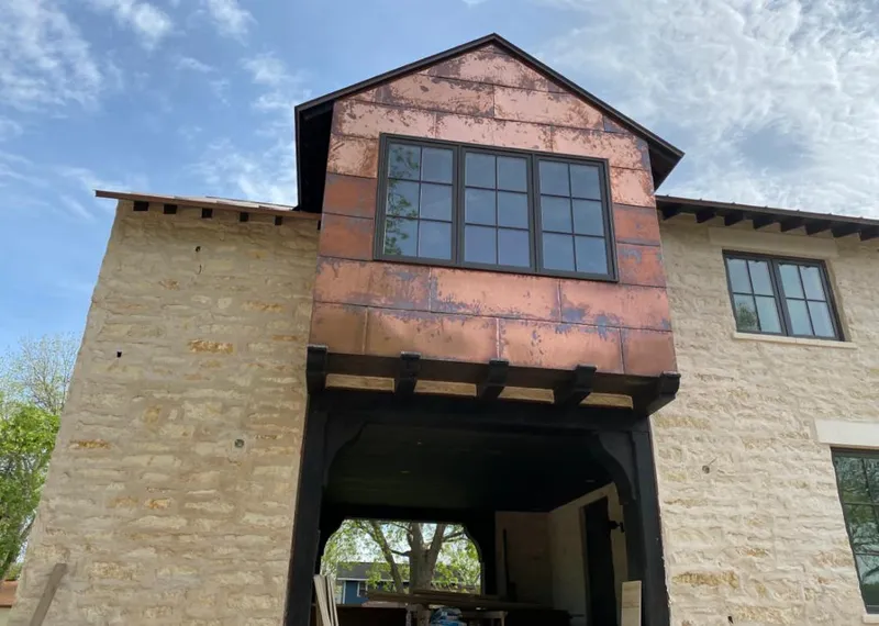 Copper metal panel facade on a stone building for Metal Roof Coating in Pine Ridge