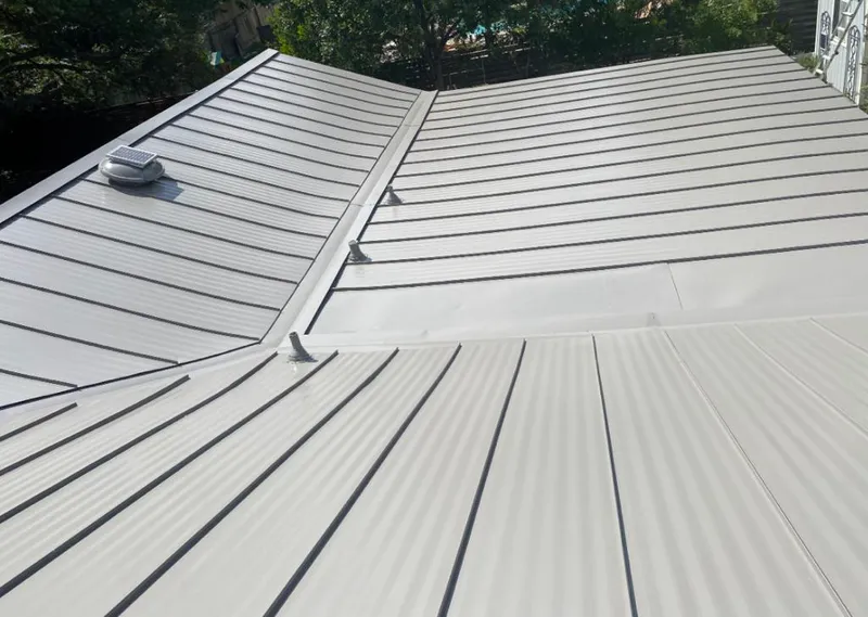 Solar attic fan installed on a metal roof for Roof Ventilation in Pine Ridge